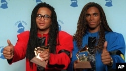 FILE - Rob Pilatus, left, and Fab Morvan of Milli Vanilli give the thumbs-up as they display their Grammys after being presented with the best new artist award in Los Angeles, Feb. 21, 1990.