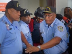 Gabriel Alexander Pérez Vizcaino, alias "Bone," behind wearing helmet, a suspect in the shooting of former Boston Red Sox slugger David Ortiz, is taken to court in Santo Domingo, Dominican Republic, June 17, 2019.