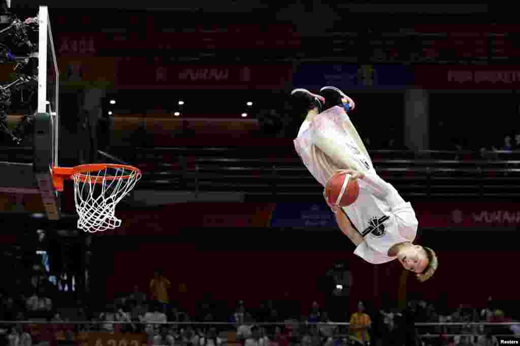 A dunk artist performs during halftime at the FIBA World Cup basketball match between South Korea and Nigeria in Wuhan, China.