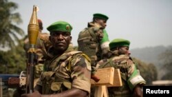 Soldiers from the AU peacekeeping mission prepare to leave at the end of a speech given by Alexandre-Ferdinand Nguendet, the head of Central African Republic's transitional assembly at the Gendarmerie headquarters in Bangui on Jan. 13, 2014. 