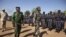 Ivory Coast army chief-of-staff Soumaila Bakayoko (L) and Malian army chief-of-staff Ibrahima Dahirou Dembele (C) inspect Malian troops at an air base in Bamako, Mali, January 16, 2013. 