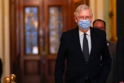 FILE - Senate Majority Leader Mitch McConnell of Kentucky walks from the Senate floor to his office on Capitol Hill, Jan. 6, 2021.