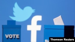 3-D-printed ballot boxes are seen in front of a displayed Twitter logo in this illustration taken Nov. 4, 2020.