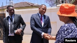 Botswana opposition leader Duma Boko shakes hands with a woman after his party UDC won the general election, outside his home in Gaborone, Botswana, Nov. 1, 2024