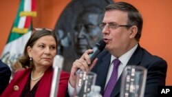 Mexican Foreign Minister Marcelo Ebrard, right, accompanied by Mexican Ambassador to the U.S. Martha Barcena, speaks during a news conference at the Mexican Embassy in Washington, June 3, 2019.