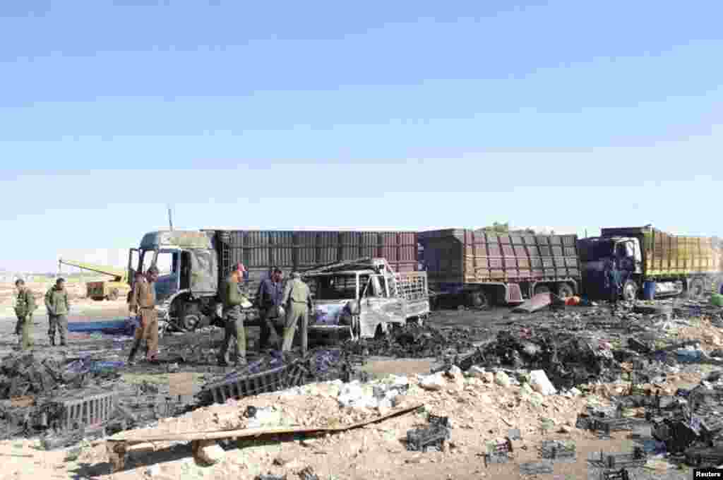 Men inspect the site after a suicide attack at the eastern entrance of Hama city, in this handout photograph distributed by Syria's national news agency SANA on Oct. 20, 2013. 