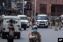 Indian policemen guard at a closed market during a strike by separatists on the second anniversary of India’s revocation of the disputed region’s semiautonomy in Srinagar, Indian-controlled Kashmir, Aug. 5, 2021.