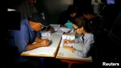 Officials count ballots after polls have been closed at a polling station in Rabat, Morocco, Oct. 7, 2016.