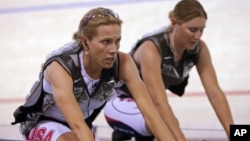 Dotsie Bausch (L) and teammate Lauren Michelle warm up at the World Track Cycling Championships in the Ballerup Arena, Copenhagen, Denmark, March, 24, 2010. 