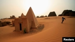 FILE - A boy plays near the site of 44 Nubian pyramids of kings and queens in the ruins of the ancient city of Meroe at Begrawiya, near Shendi in the River Nile state of Sudan March 10, 2012. (REUTERS/ Mohamed Nureldin Abdallah)