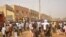 People rush to the scene of explosions at a bus park in Sabon Gari, where the Islamist sect Boko Haram is waging an insurgency against the government, in Kano, Nigeria, March 19, 2013.