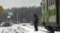 Rescue and military personnel and a policeman are seen at the railroad crossing after a crash between a train and a military truck in southern Finland, Oct. 26, 2017.