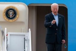 President Joe Biden points as he boards Air Force One, June 9, 2021, at Andrews Air Force Base, Md. Biden embarked on the first overseas trip of his term, eager to reassert the United States on the world stage and steady European allies.