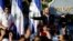 Salvadoran President Nayib Bukele gestures as he addresses his supporters protesting outside the national congress to push for the approval of funds for a government security plan in San Salvador, El Salvador February 9, 2020.