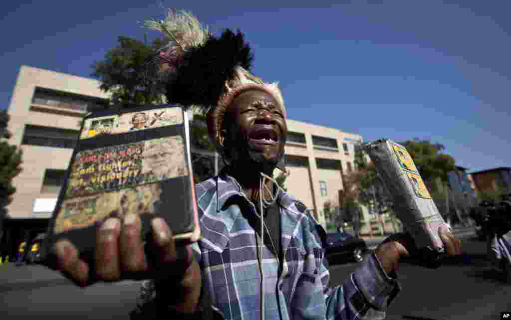 Wellwisher Daniel Sello cries out his thanks to former South African President Nelson Mandela in front of the Mediclinic Heart Hospital where he is being treated in Pretoria.