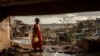 FILE - A young girl walks in the Kaweni slum on the outskirts of Mamoudzou, in the French Indian Ocean island of Mayotte, Dec. 19, 2024, after Cyclone Chido. 