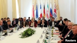 Iran's top nuclear negotiator Abbas Araqchi and Secretary General of the European External Action Service (EEAS) Helga Schmit attend a meeting of the JCPOA Joint Commission in Vienna, Austria, June 28, 2019.