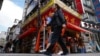 Commuters walk past a Chinese grocery store that's popular among Chinese living in Japan, Sept. 4, 2024, in Tokyo. Some Japan experts say Beijing’s transnational repression has created a chilling effect within the Chinese diaspora in Japan.