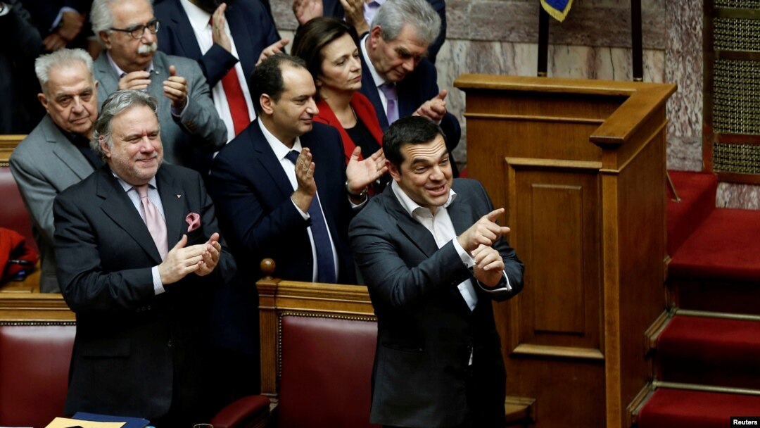 Greek Prime Minister Alexis Tsipras and members of his government applaud after a vote on an accord between Greece and Macedonia changing the former Yugoslav republic's name in Athens, Greece, January 25, 2019.