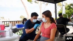 A CSULB student receives a first dose of the Pfizer Covid-19 vaccine during a City of Long Beach Public Health Covid-19 mobile vaccination clinic at the California State University Long Beach (CSULB) campus on August 11, 2021 in Long Beach,…