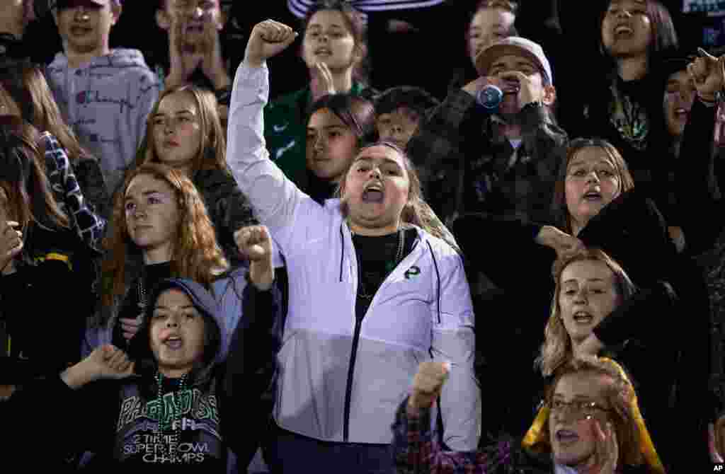 Paradise High School students cheer for their school's football team during their CIF Northern California Section Division III playoff game in Paradise, Calif., Nov. 15, 2019.