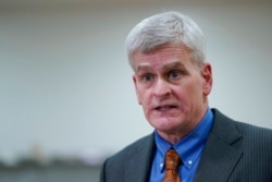 FILE - Sen. Bill Cassidy, R-La., talks with reporters on Capitol Hill in Washington, Feb. 11, 2021.