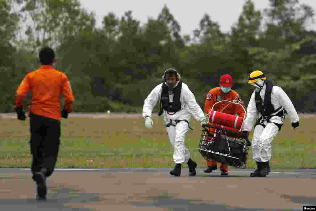 Rescue team members carry the body of a victim of AirAsia flight 8501, at Iskandar Air Base in Pangkalan Bun, Jan. 6, 2015.