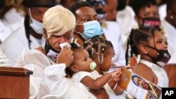 Tomika Miller, the wife of Rayshard Brooks, weeps while holding their 1-year-old daughter Dream during his funeral in Ebenezer Baptist Church on Tuesday, June 23, 2020 in Atlanta.