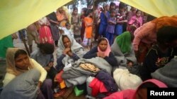 Rohingya refugees, who were on a boat traveling from Myanmar that capsized at Bailakhali beach, wait to transported to a refugee camp from the beach, near Cox's Bazar, Bangladesh, Oct. 31, 2017.