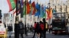 FILE - People ride a bus past flags representing Commonwealth countries next to Westminster Abbey in London on March 13, 2023. The Commonwealth is scheduled to meet Oct. 21-25, 2024, in Samoa.