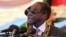 Zimbabwean President Robert Mugabe delivers his speech during a ceremony to honor thousands of fighters who died in the 1970s Bush war against colonialism, in Harare, Aug. 10, 2015.