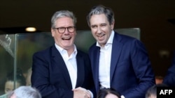 British Prime Minister Keir Starmer, left, and Irish Prime Minister Simon Harris react in the stands during the UEFA Nations League football match between Ireland and England at the Aviva Stadium in Dublin on Sept. 7, 2024.