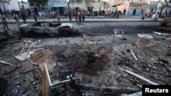 People gather in the aftermath of an explosion that happened Sunday night outside the Oromo restaurant in Mogadishu, Oct. 13, 2014. 