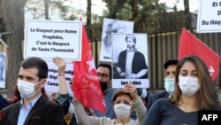 Demonstrators hold a sign reading "Respect for our prophet is respect for all mankind" during a demonstration protesting the cartoons of French satirical Charlie Hebdo, in front of the French embassy in Ankara, on Oct. 28, 2020. 