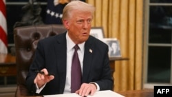 President Donald Trump signs an executive order on the U.S. withdrawal from the World Health Organization in the Oval Office of the White House in Washington, on Jan. 20, 2025.