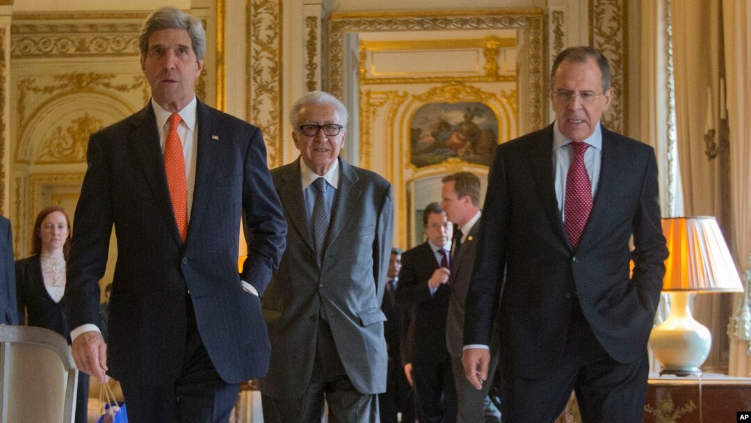 US Secretary of State John Kerry, left, walks with Russia's Foreign Minister Sergey Lavrov, right, and U.N-Arab League envoy for Syria Lakhdar Brahimi, center, before the start of their joint news at the US Ambassador's residence in Paris, France, Jan. 13, 2014.