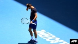 Novak Djokovic of Serbia wipes the sweat from his brow during a practice session ahead of the Australian Open at the Melbourne Park tennis centre in Melbourne on January 12, 2022. (Photo by William WEST / AFP)