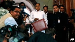 Indian Finance Minister Palaniappan Chidambaram, center, arrives at Parliament to present the annual budget in New Delhi, February 28, 2013.