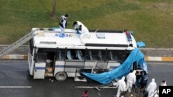 Forensic police cover a damaged police vehicle after a bomb went off near the country's ruling party offices in Turkey's largest city, Istanbul, March 1, 2012.