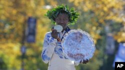 First place finisher Mary Keitany of Kenya poses for a picture at the finish line of the New York City Marathon in New York, Sunday, Nov. 4, 2018. 