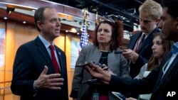 FILE - Rep. Adam Schiff, left, a Democrat from California and ranking member of the House Intelligence Committee, speaks with reporters after a news conference in Washington, July 17, 2018.