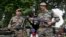 Indian army soldiers display seized arms and ammunition at the army headquarters in Srinagar, India, August 16, 2013. 