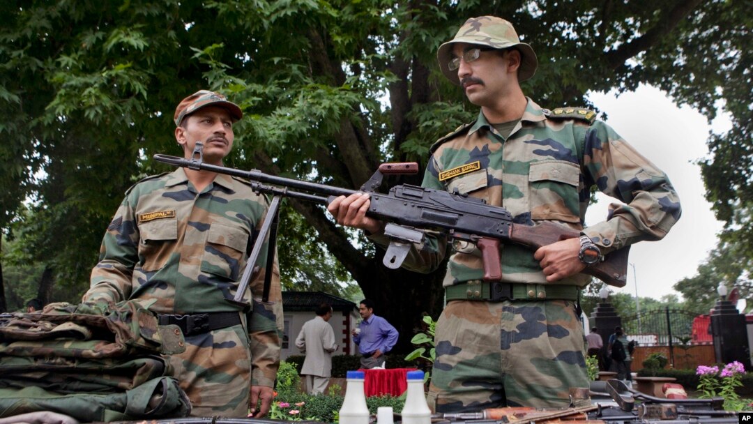 Indian army soldiers display seized arms and ammunition at the army headquarters in Srinagar, India, August 16, 2013. 