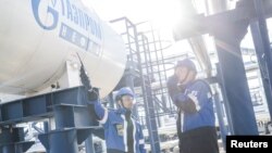 Employees work at the Alexander Zhagrin oilfield operated by Gazprom Neft in Khanty-Mansi Autonomous Area–Yugra