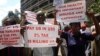 Teachers hold banners during a protest against the high cost of living, in Zimbabwe's capital Harare on Nov. 9, 2018.