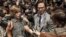 FILE - This image from Sony Pictures shows Michelle Williams, left, and Mark Wahlberg in "All The Money in the World." After an outcry over a significant disparity in pay with Williams, Wahlberg has agreed to donate the $1.5 million he earned for reshoots on the movie to the anti-sexual misconduct initiative Time’s Up, in Williams' name.
