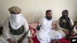 Taliban No 2 commander Waliur Rehman, center, flanked by militants, talks to the Associated Press in Shawal area of South Waziristan along the Afghanistan border in Pakistan.