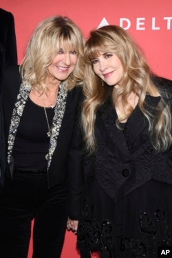 FILE - Honorees Christine McVie, left, and Stevie Nicks of Fleetwood Mac appear at the 2018 MusiCares Person of the Year tribute honoring Fleetwood Mac in New York on Jan. 26, 2018. (Photo by Charles Sykes/Invision/AP, File)