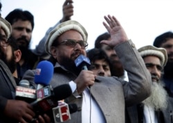 FILE - Hafiz Saeed, chief of Pakistani religious group Jamaat-ud-Dawa, addresses a rally for Kashmir Day in Lahore, Pakistan, Feb. 5, 2019.