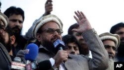 FILE - Hafiz Saeed, chief of Pakistani religious group Jamaat-ud-Dawa, addresses a rally for Kashmir Day in Lahore, Pakistan, Feb. 5, 2019.